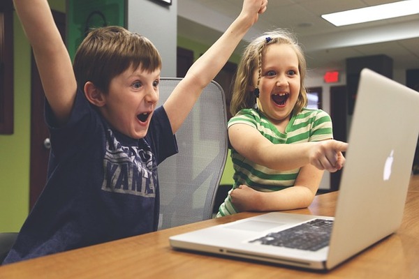 Een goede reputatie - Kinderen die enthousiast achter een laptop zitten. Foto: StartUpStockphoto